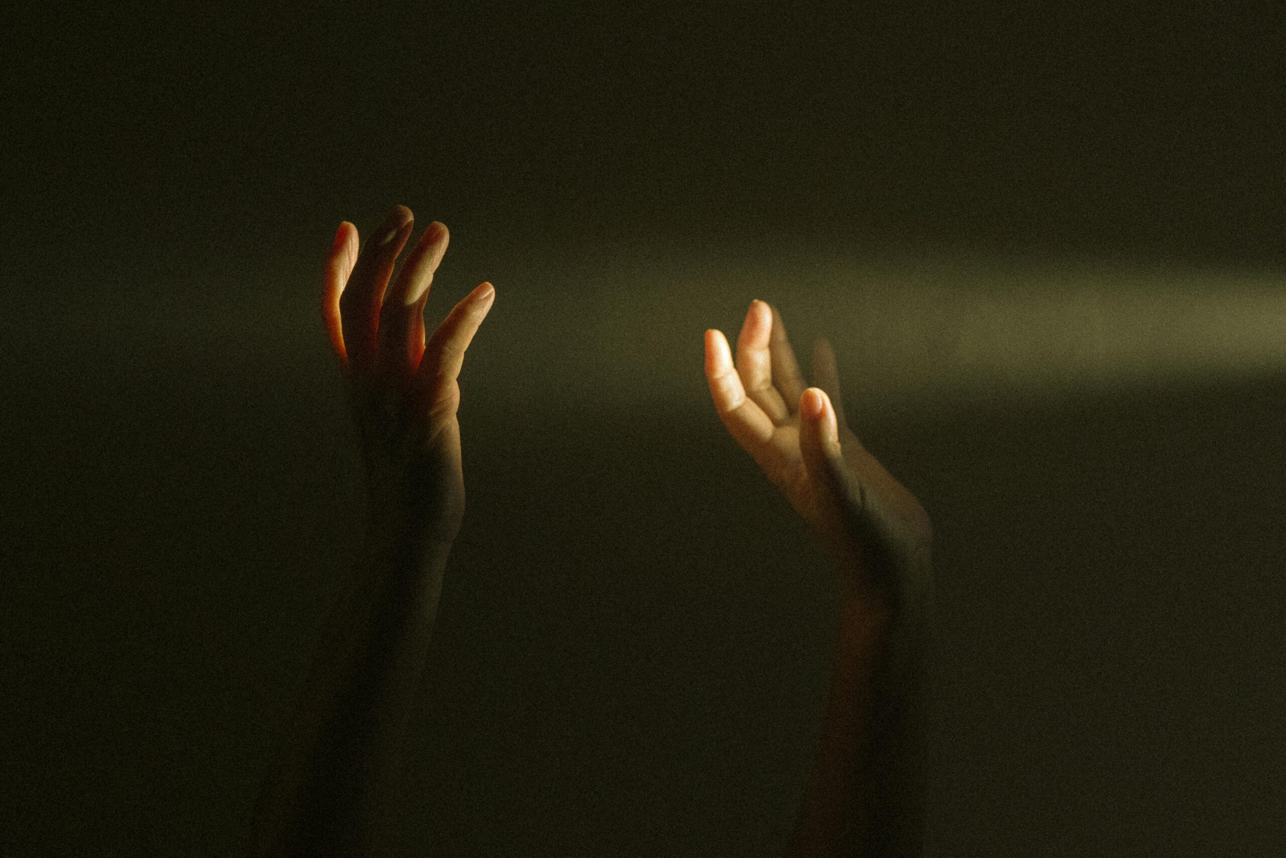 pexels-photo-3978594-3978594 Expressive hands reaching towards a ray of light symbolize hope and mental resilience.
